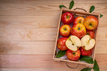 Fresh red Envy apple in wooden basket on wooden background. Envy apple on wooden box packaging...