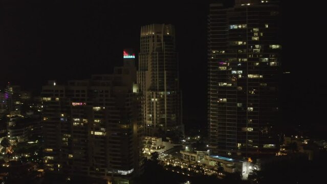 Beautiful Miami city night scene with illuminated buildings. Aerial circling