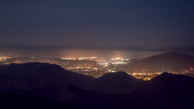 A time lapse taken from TV Tower Road in the Los Padres National Forest, looking at San Louis Obispo on a foggy night, California.