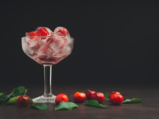 Wine glass with cherry juice on a black background.