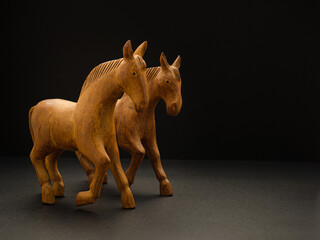 Old wooden horses over on the black background.