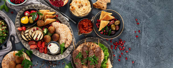 Arabic food assortment on dark background.