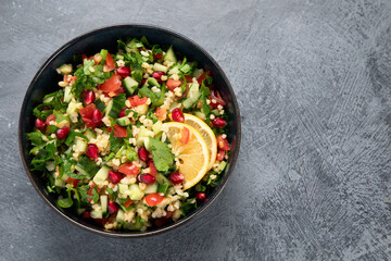 Fresh Tabbouleh salad on dark background.
