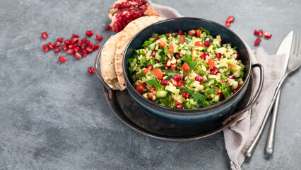 Fresh Tabbouleh salad on dark background.