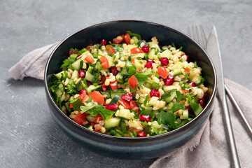 Fresh Tabbouleh salad on dark background.