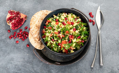 Fresh Tabbouleh salad on dark background.