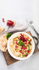 Bulgur and hummus salad on light background.