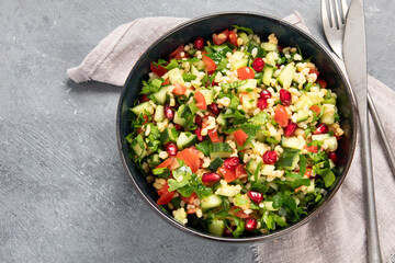 Fresh Tabbouleh salad on dark background.