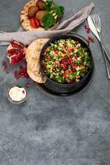 Fresh Tabbouleh salad on dark background.