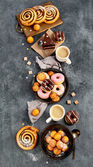 Table with various cookies, donuts, cakes and coffe cups