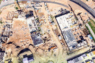 Fototapeta premium concrete construction site with working cranes and high-rise apartment buildings under construction. aerial drone photo.