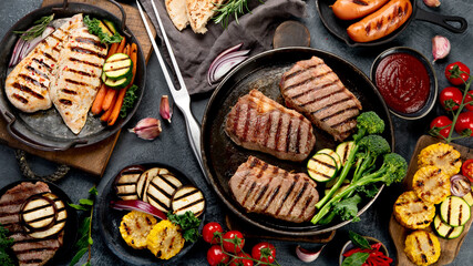 Grilled barbecue meat assortment on dark background.