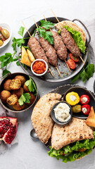 Lebanese food assortment on light background.
