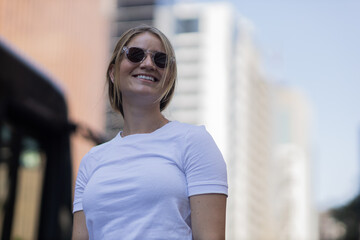 Portrait of a beautiful blonde woman  on a big city street on an urban background. High quality photo