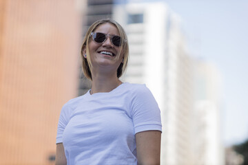 Portrait of a beautiful blonde woman  on a big city street on an urban background. High quality photo