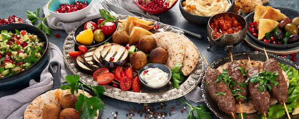 Arabic food assortment on dark background.