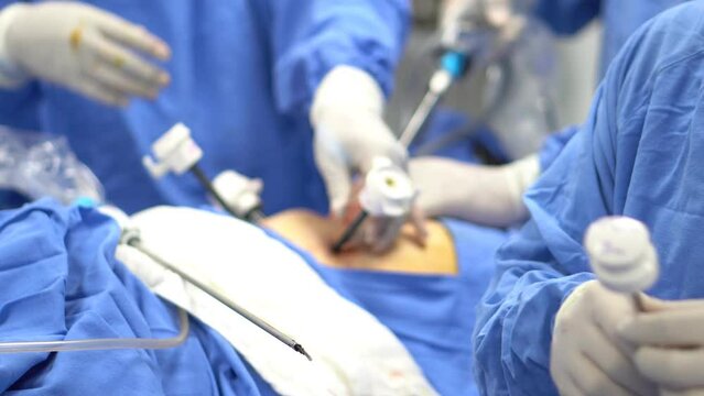 The surgeon's holing the instrument in abdomen of patient during laparoscopic