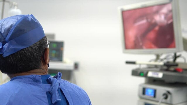 surgeon's view on the monitor during a laparoscopy operation in his blue sterilized suit