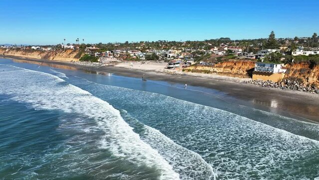 Beautiful scenery of sea and city. Warm sunny day at Moonlight Beach in Encinitas in Southern California. Drone shot over the beaches.