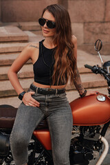 Fototapeta na wymiar Attractive female hipster and retro style motorbike outdoors