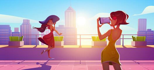 Woman posing on rooftop terrace for photo shoot. Girls in summer dresses stand on house roof photographing each other on mobile at cityscape background with skyscrapers, Cartoon vector illustration