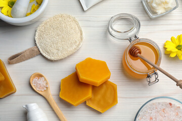 Flat lay composition with beeswax on white wooden table