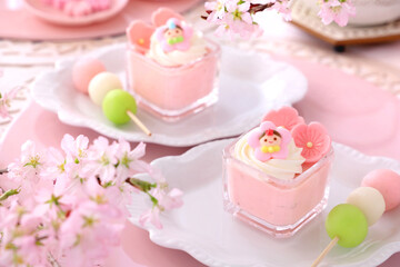 Obraz na płótnie Canvas Cherry blossom mousse dessert with whipped cream in glasses. Home made spring glass dessert for Japanese Doll's Festival . おひな祭り　ひな祭り　さくらババロア　さくらプリン