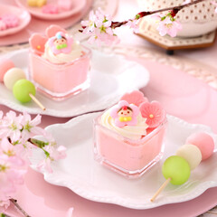 Cherry blossom mousse dessert with whipped cream in glasses. Home made spring glass dessert for...