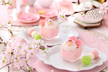 Obraz na płótnie Canvas Cherry blossom mousse dessert with whipped cream in glasses. Home made spring glass dessert for Japanese Doll's Festival .お　ひな祭り　ひな祭り　さくらババロア　さくらプリン
