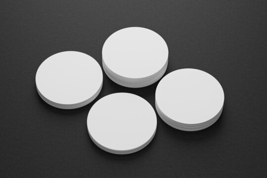 3d mockup of a round business card on a black paper background