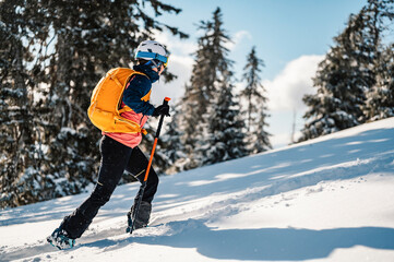 Mountaineer backcountry ski walking ski woman alpinist in the mountains. Ski touring in alpine...