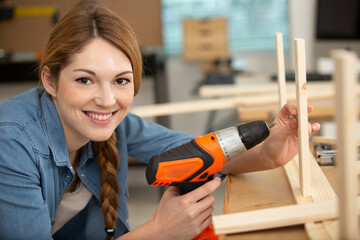 pretty young woman holding screwdriver