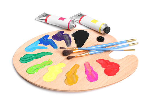 Palette with acrylic paints and brushes on white background. Artist equipment