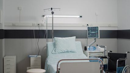 Nobody in hospital ward with bed for patient healthcare. Empty reanimation room with medical equipment, tools and computer for files and checkup information. Space for intensive care