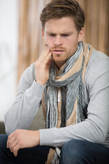Fototapeta premium frustrated young man suffering from tooth ache