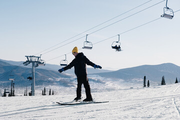 Portrait of happy young man living with a chronic health condition, skiing in ski resort. Winter sport outdoor