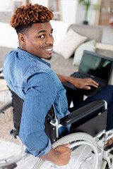 smiling disable young man in wheelchair