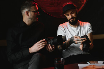 Working on creative project together. Two confident business people in casual wear sitting together at the table and discussing something