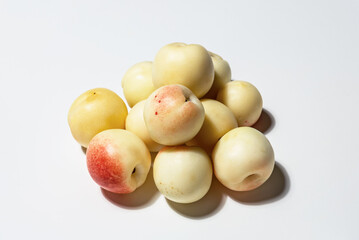 A bunch of farm-fresh white Uzbek nectarines on a white background