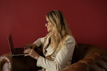 Young woman working at home with laptop and papers and headphones. Home office concept.