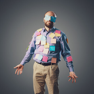 Confused businessman covered with sticky notes