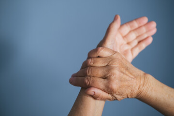 Old woman hands measuring her pulse. Heart health problems in old age