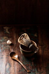  Bamboo tea whisk on rustic wooden background.