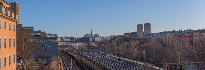 Panorama bridge view over the canal Karlbergskanalen, apartment and office houses by the train tracks and the traffic route Karlbergsleden a winter day in Stockholm