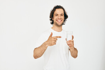 Fototapeta premium Cheerful man in a white T-shirt glass of water Lifestyle unaltered