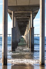 Vertical View Under Ocean Beach Pier Wooden Structure.  San Diego California Pacific Coast Scenic Detail on a Clear Sunny Winter Day