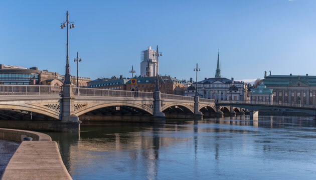 The bridge Vasabron at the river Norrstr&ouml;m with ice floes and a skyline with the old town Gamla Stan a sunny winter day in Stockholm