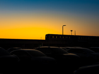 Fototapeta premium Silhouette of sky train inbound or outbound in the beautiful sunset.