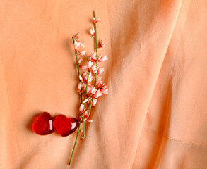 pink flowers and red hearts on silk background