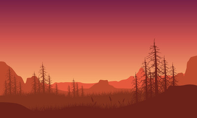 Great mountain view with tree silhouettes from the out of town at dusk